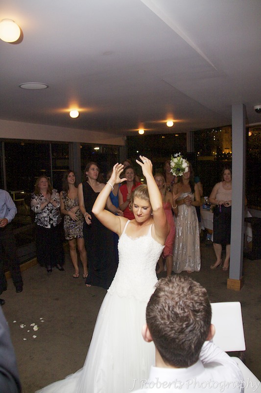 Bride throwing the bridal bouquet to single girls - wedding photography sydney